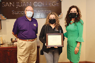 Kristina Lacey holding a framed certificate and standing with Joe Rasor and Dr Pendergra