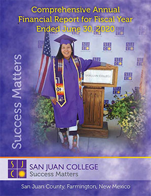 Student in cap and gown on the cover of the Comprehensive Annual Financial Report