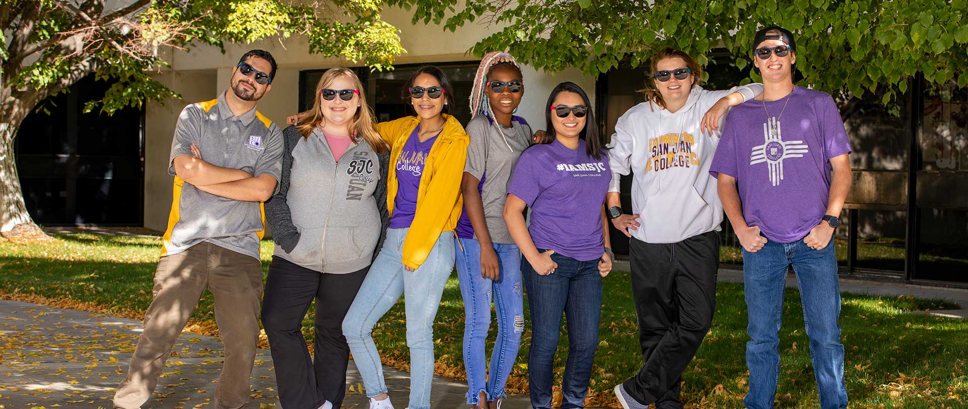 SJC Students in their SJC gear standing in a common area outside