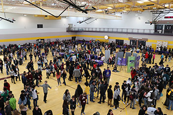 8th grade students in the SJC gym looking at a career fair and opportunities available to them in the future. 